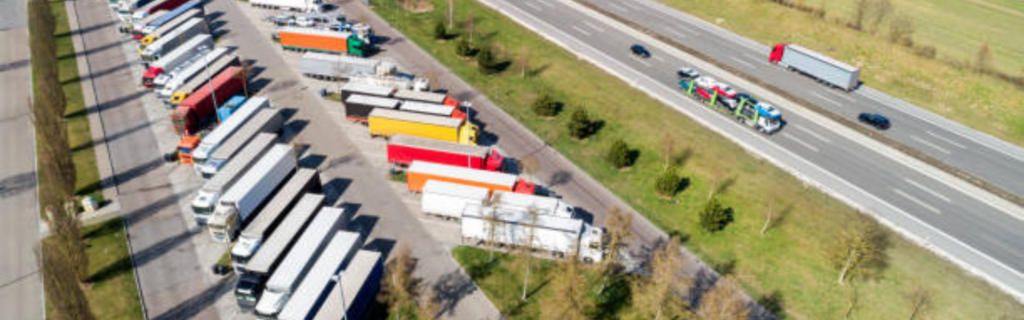 Semi trucks parked at roadside rest area
