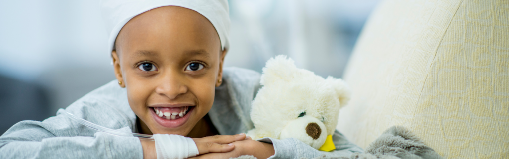 child in cancer ward with teddy bear