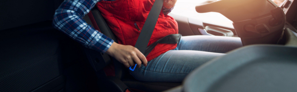 female trucker buckling seat belt