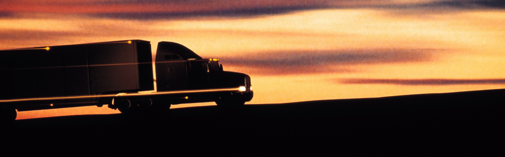 silhouette of semi truck in sunset