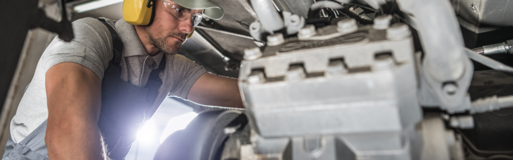diesel technician working on engine