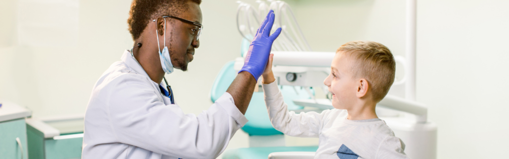 doctor high fiving child patient