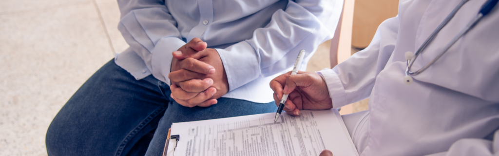 doctor filling out form with patient