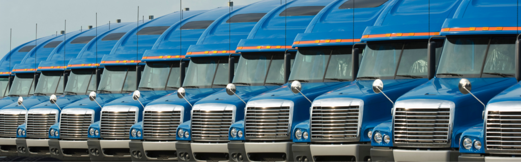 Line of parked blue semi trucks