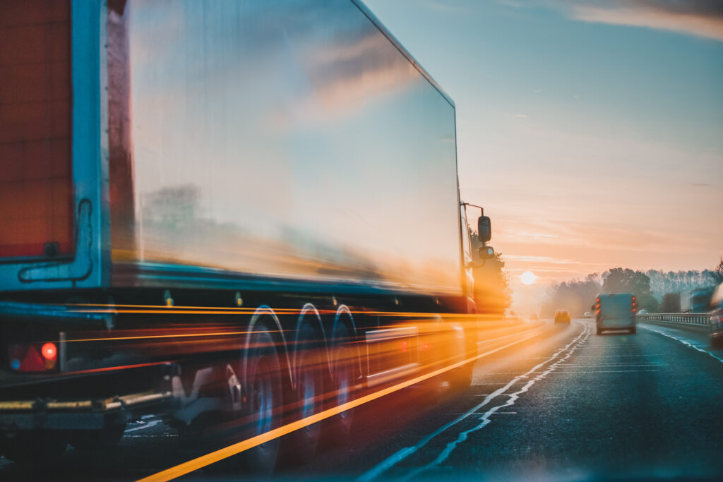 Semi Truck driving fast at dusk