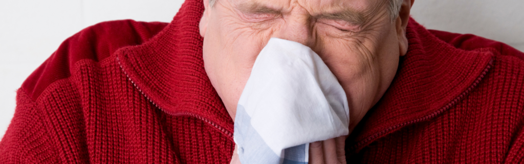 man blowing nose