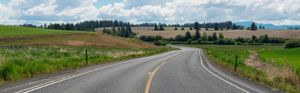highway with farm fields on either side