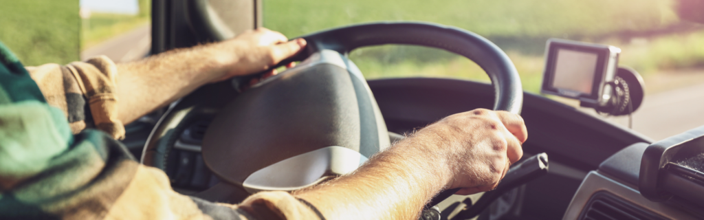 hands on the wheel of a semi truck