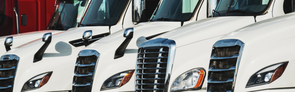 new white semi trucks parked in a line